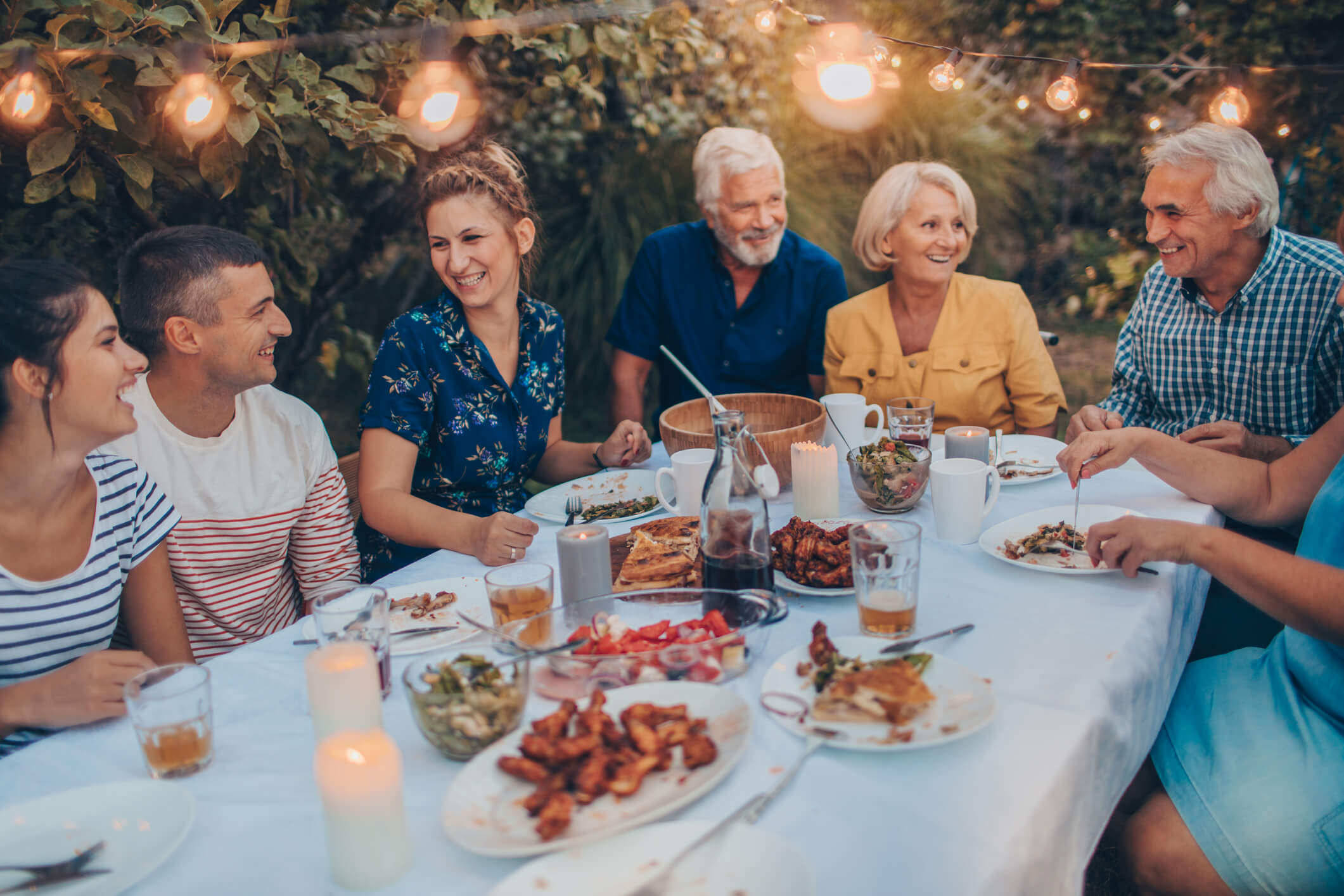 Happy family eating dinner outside